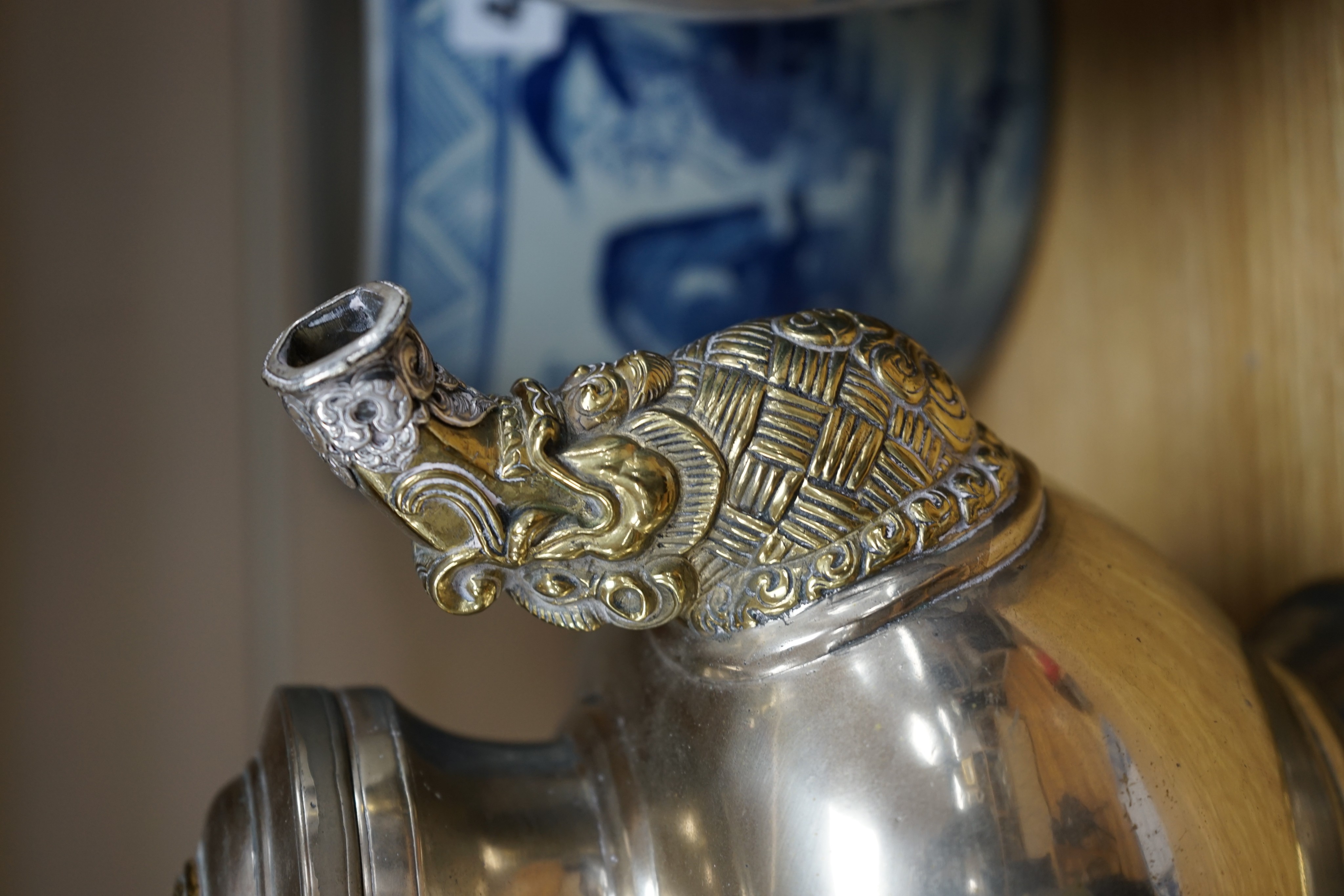 A late 19th/early 20th century Tibetan paktong, bronze and silver mounted teapot, 24cm